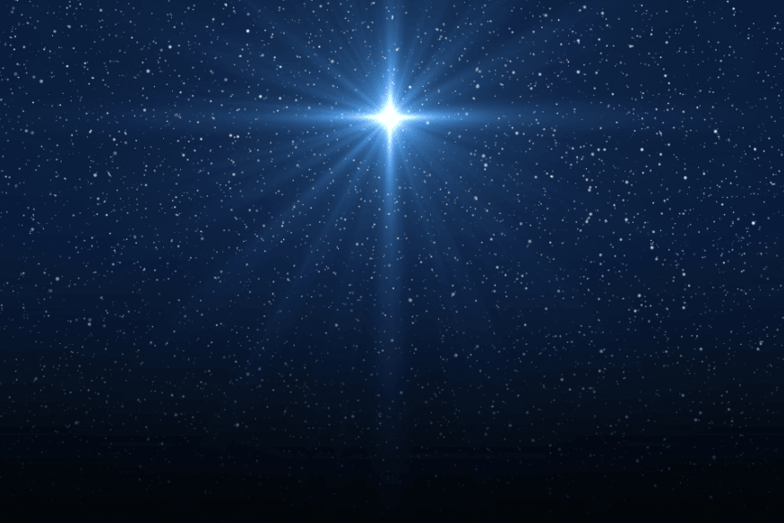 Estrela muito brilhante em destaque no céu noturno azul, com raios luminosos ao redor e várias estrelas menores ao fundo.