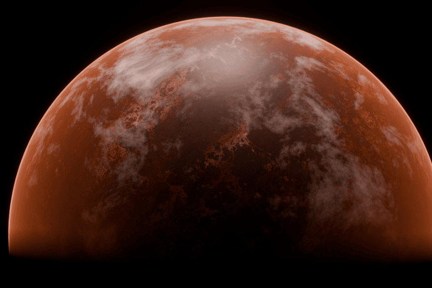 Marte visto parcialmente iluminado, com atmosfera avermelhada e nuvens claras sobre a superfície do planeta vermelho.